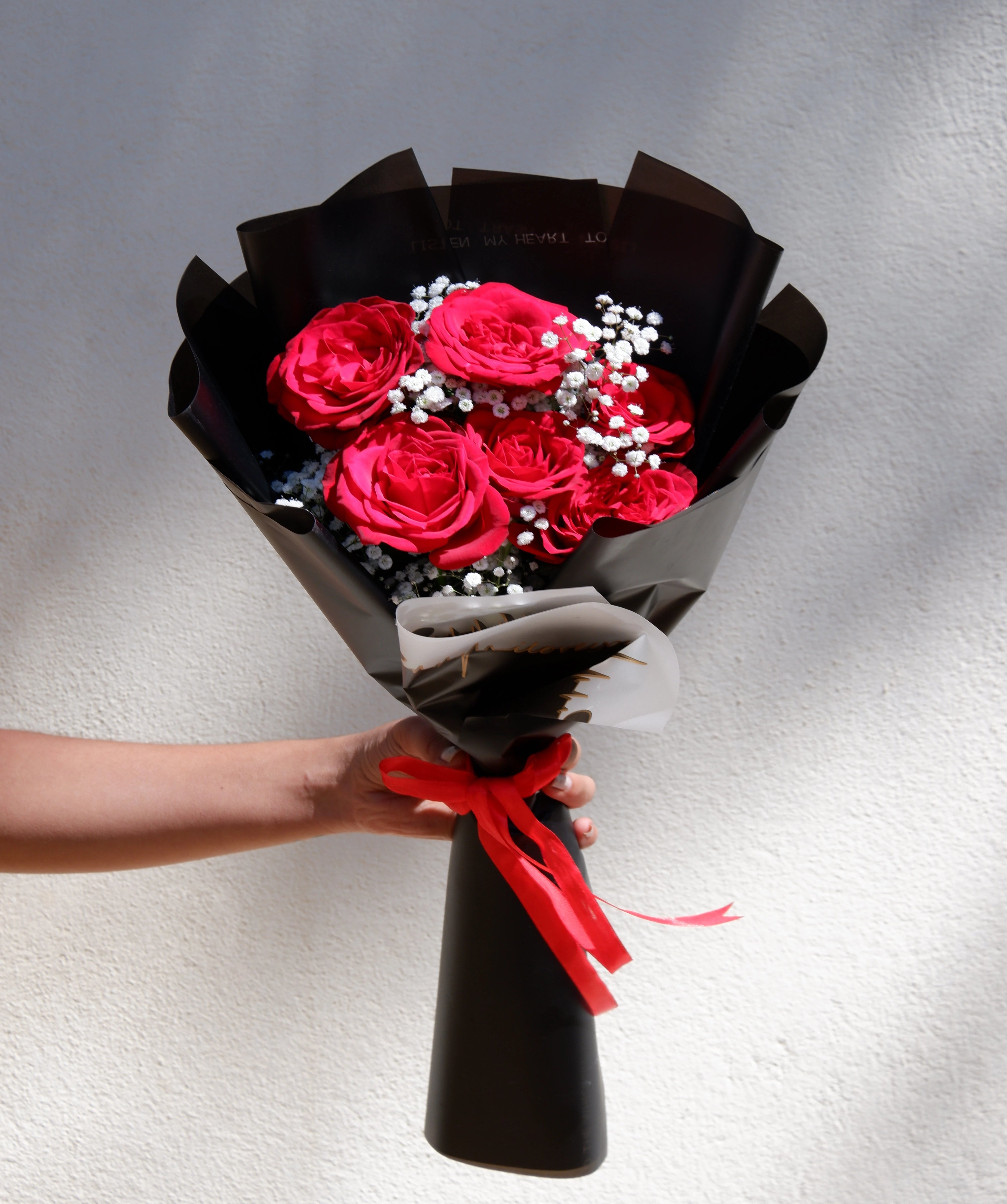 Vibrant red rose bouquet with baby's breath